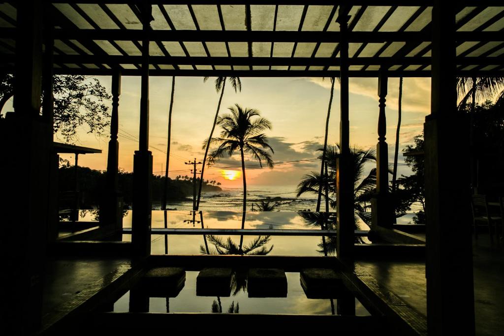 a view of the sunset from the lobby of a resort at Nuga Eden Tangalle in Tangalle
