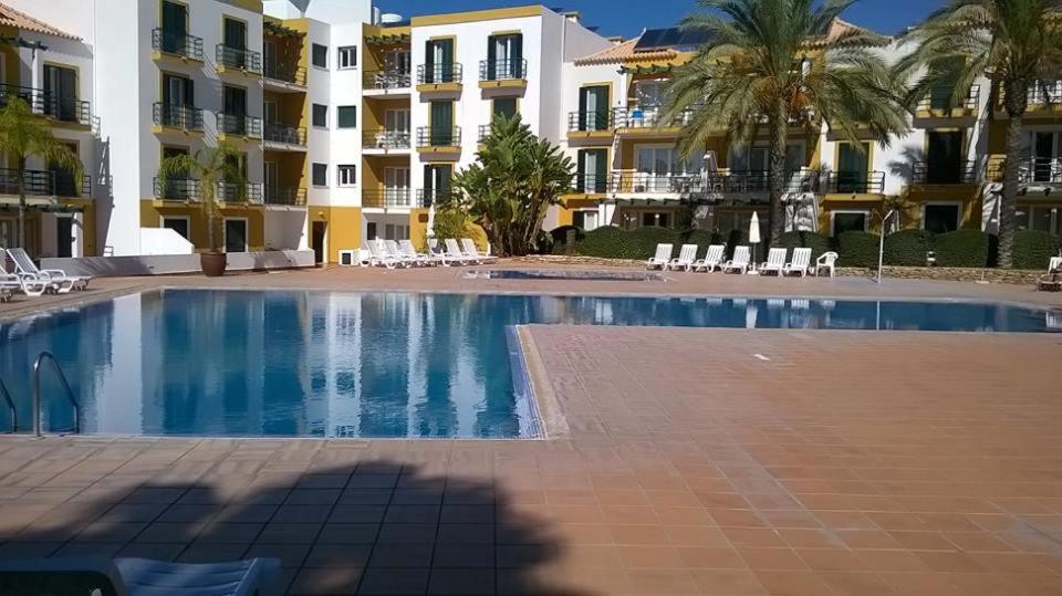 a large swimming pool in front of a building at Garden Apartment Quinta do Morgado in Tavira