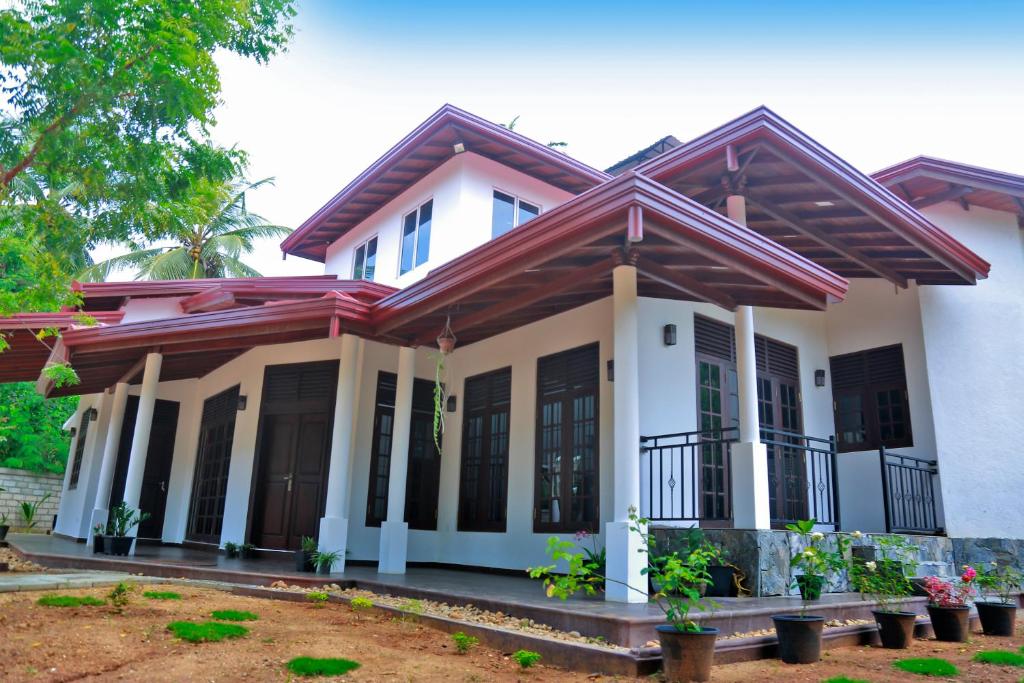 a house with a white at Kottamba Yala Stay & Safari in Tissamaharama