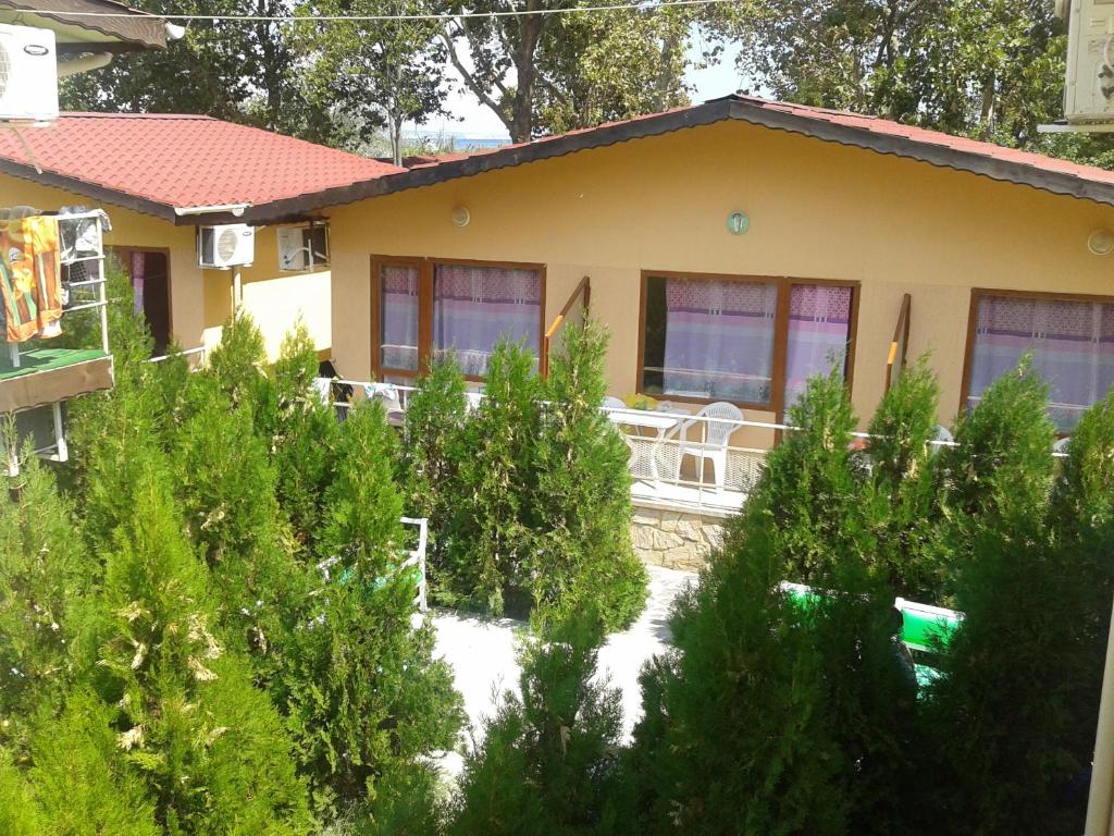 a house with trees in front of it at Вили Бийчхаус in Kranevo