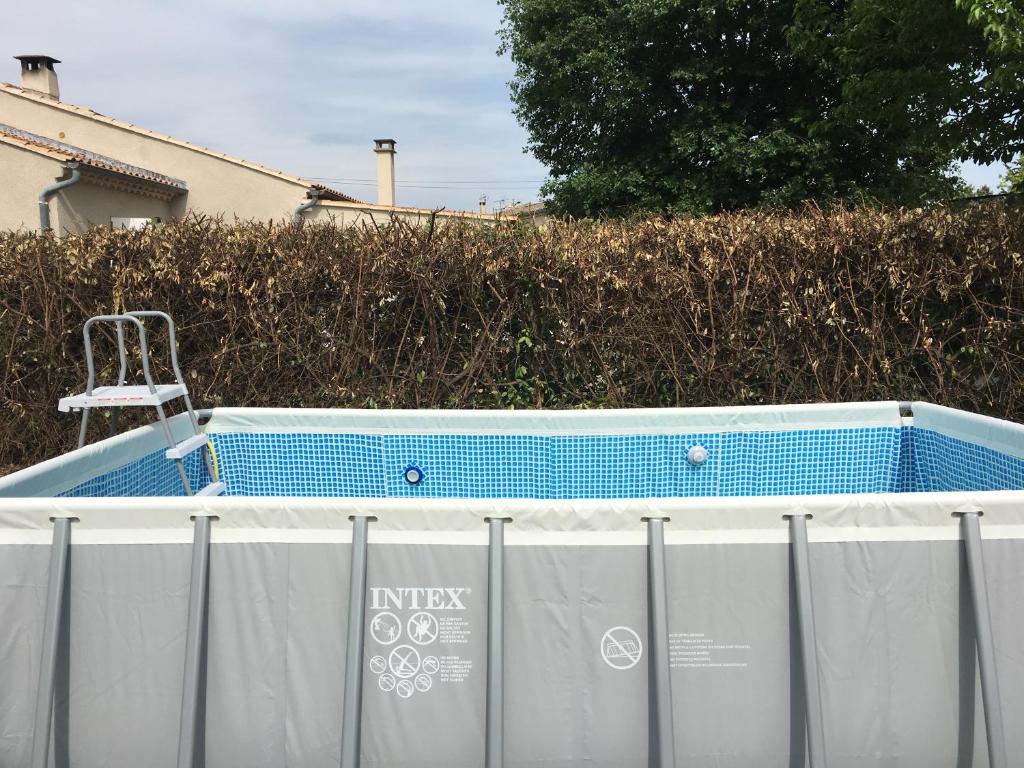 a hot tub with a chair sitting in it at Maison de village in Velleron