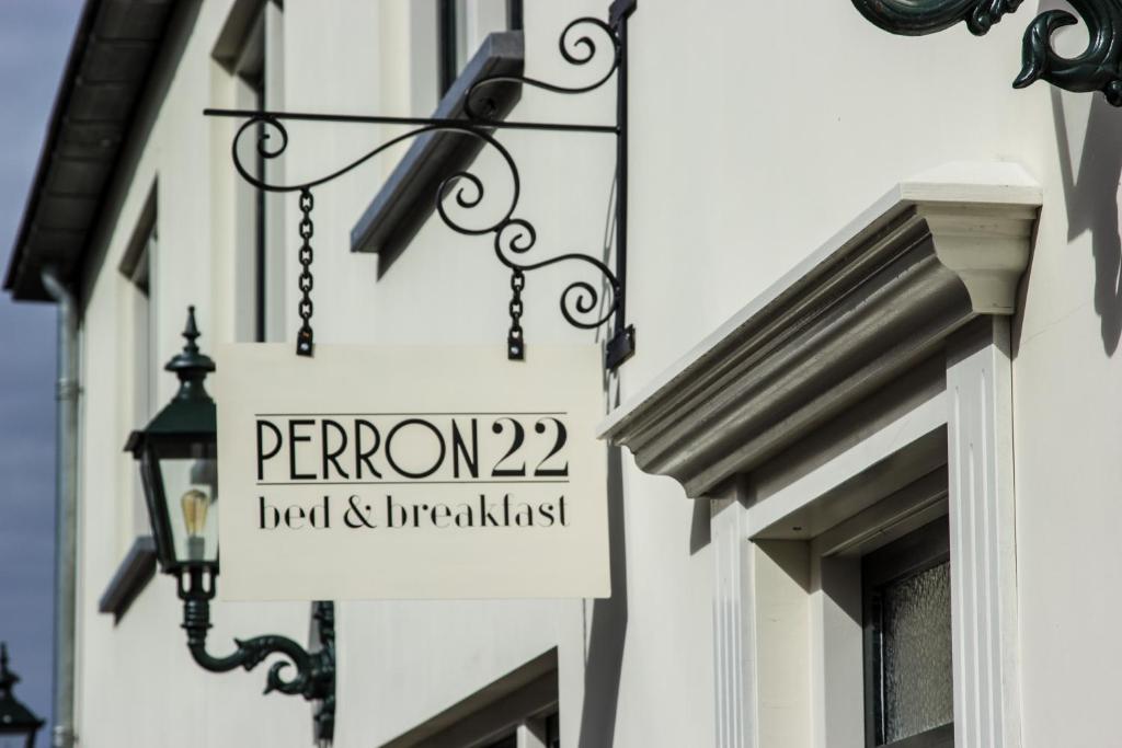 um sinal para um restaurante na lateral de um edifício em B&B Perron 22 em Vierlingsbeek