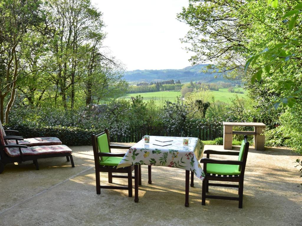 a table and two chairs and a table with a tablecloth at Beautiful holiday home with terrace in Onlay in Onlay