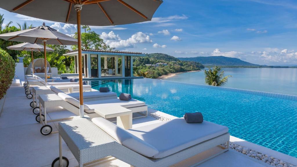 a pool with lounge chairs and a swimming pool at Ocean's 11 Villa in Ban Pa Khlok