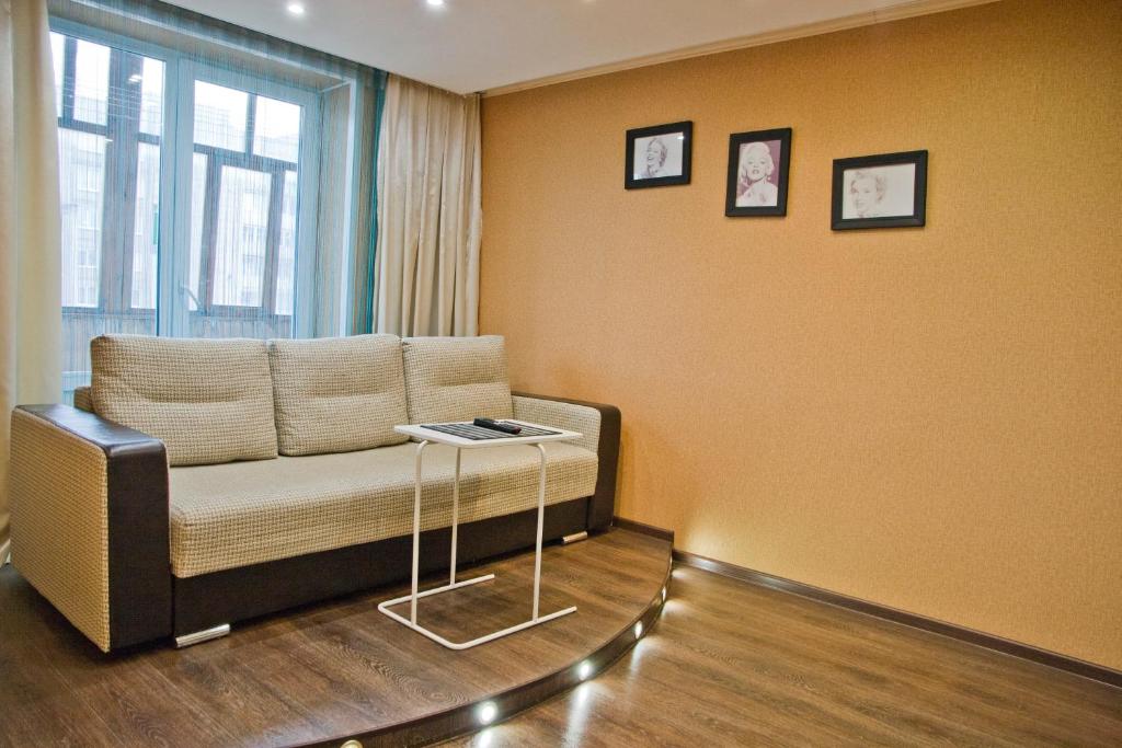 a living room with a couch and a table at Express Apartments Mira 110 in Berezniki