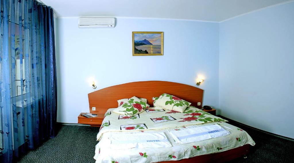 En eller flere senge i et værelse på Hotel Lidia