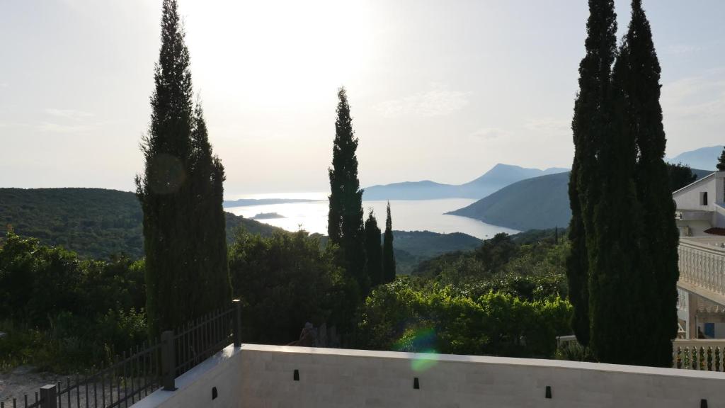 a view of the hills from a villa with cypress trees at Villa Lustica in Luštica