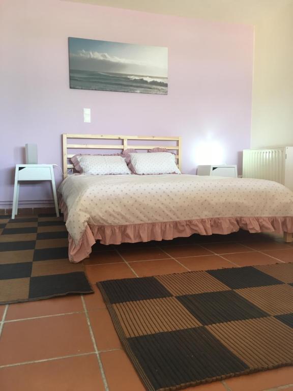 a bedroom with a bed and a painting on the wall at Traditional Studio Near Airport and Beach in Karteros