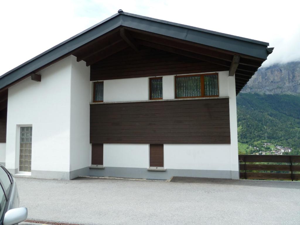 a white building with a black roof at Haus Stadel Wohnung Nr. 36 in Albinen