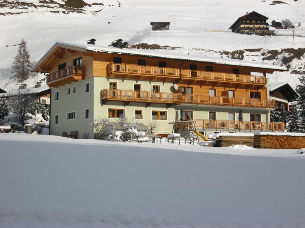a building with snow in front of it at Ferienwohnungen Steidl in Innervillgraten