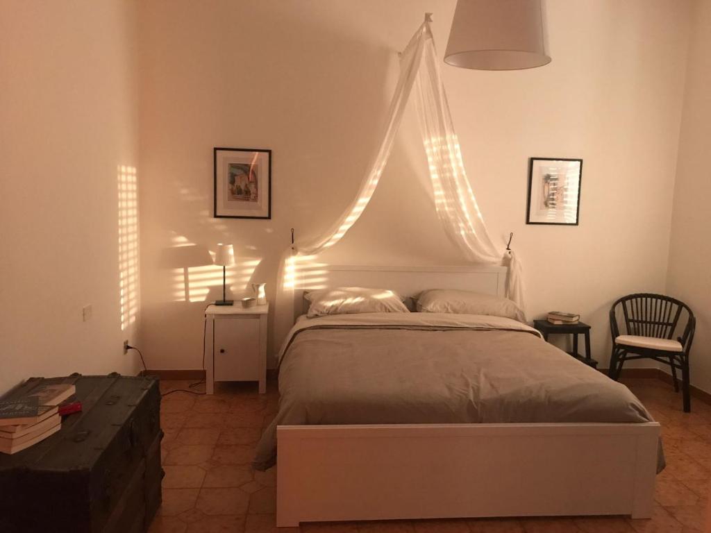 a bedroom with a bed with lights on the wall at Villa Palmina in Castelnuovo Parano