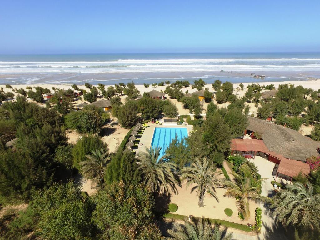 an aerial view of a resort with a swimming pool and the beach at Diamarek Hotel Sur La Plage in Saint-Louis