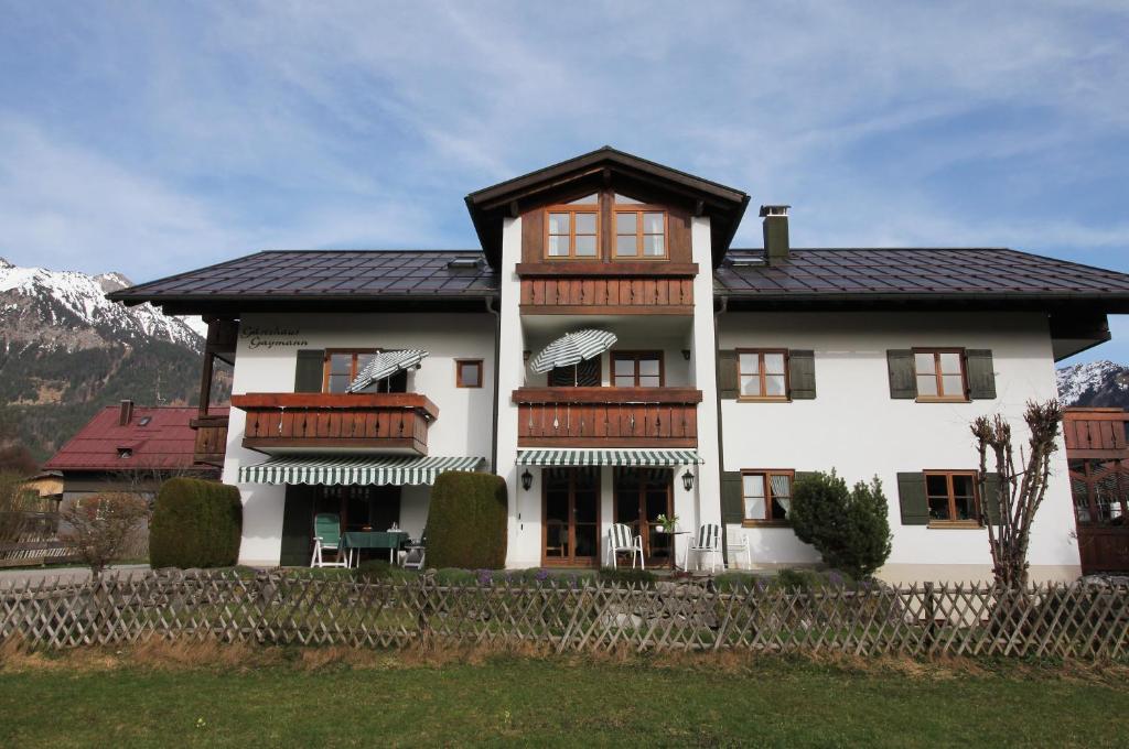 a large white house with a gambrel roof at Gästehaus Gaymann in Oberstdorf