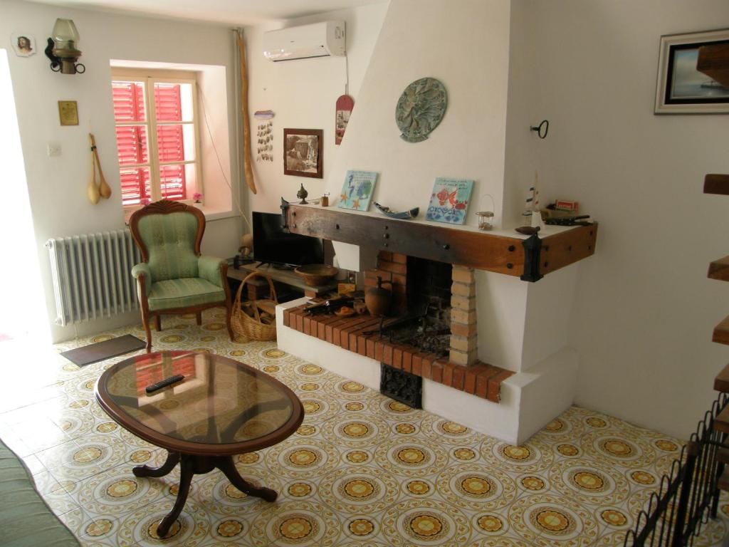a living room with a fireplace and a table at Stone House in Buljarica in Petrovac na Moru