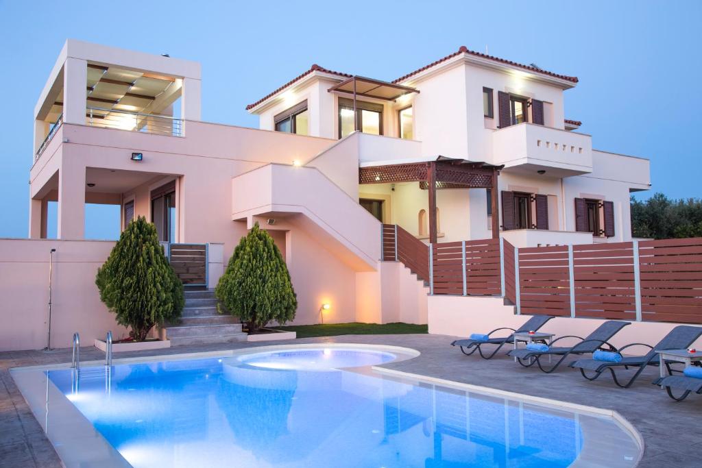 een villa met een zwembad voor een huis bij Villa Saint George in Maroulás