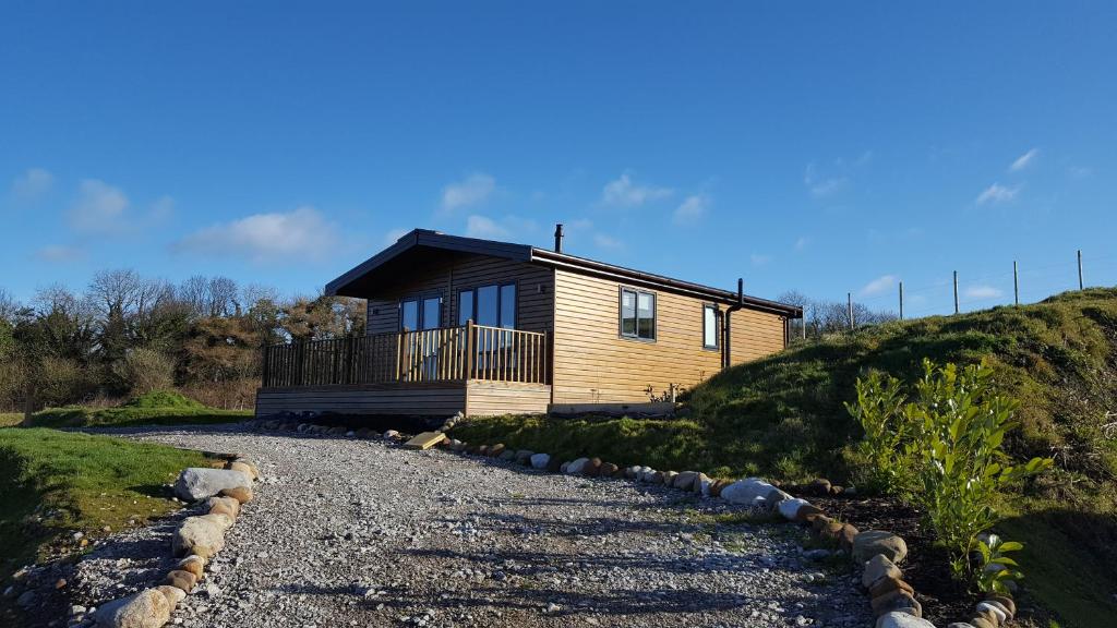 a wooden house on a hill with a gravel driveway at Lunecliffe Country lodge-Lancaster Gateway to the Lakes in Lancaster