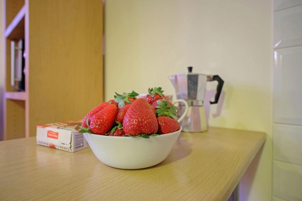 a bowl of strawberries sitting on top of a counter at Studio On Tehnika 19 in Tallinn