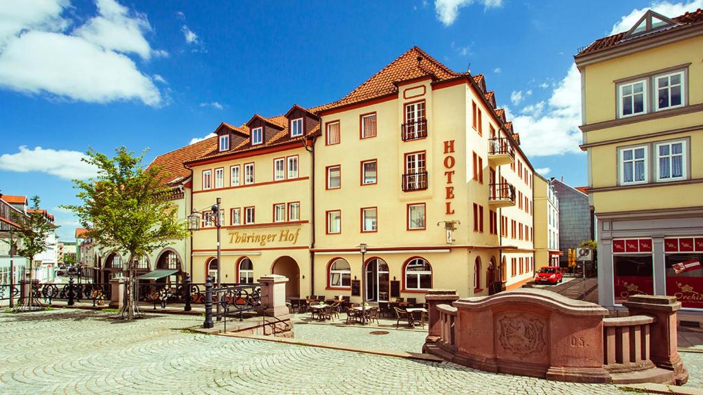 a large building on a street in a city at Hotel Thüringer Hof in Sondershausen