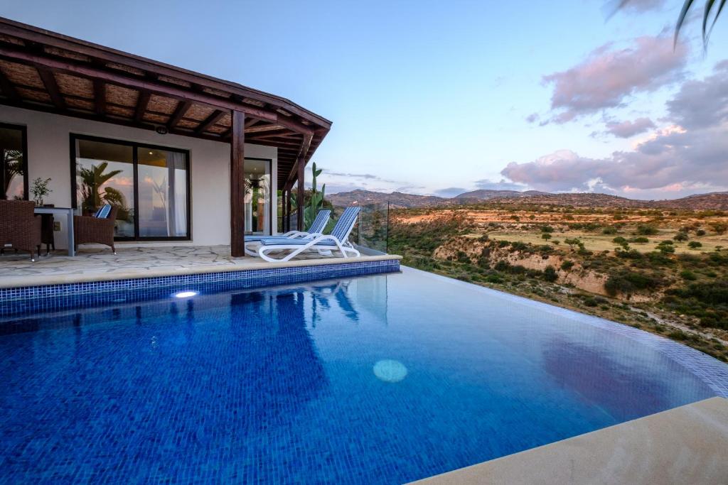 a villa with a swimming pool with a view at Villa Thea in Peyia