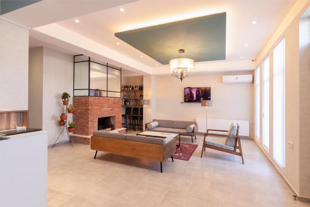a living room with a couch and a fireplace at Hotel Amser in Tbilisi City