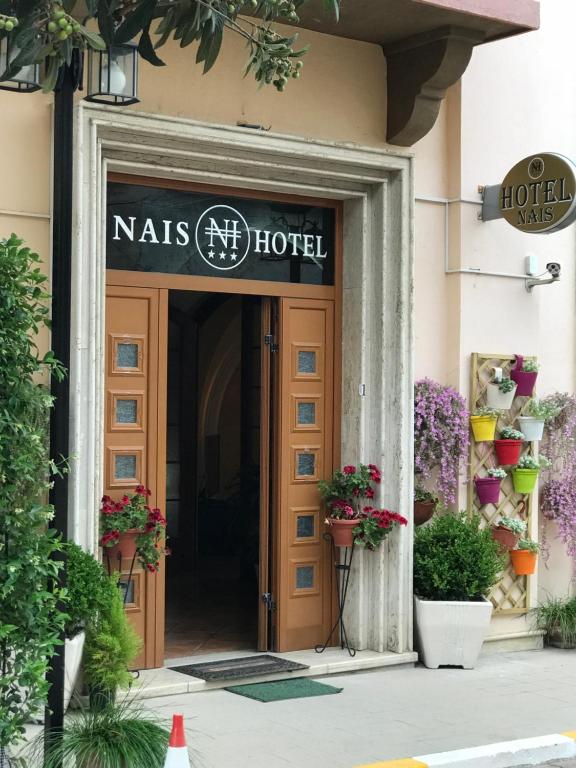 a entrance to a nars hotel with a sign over the door at Hotel Nais in Durrës