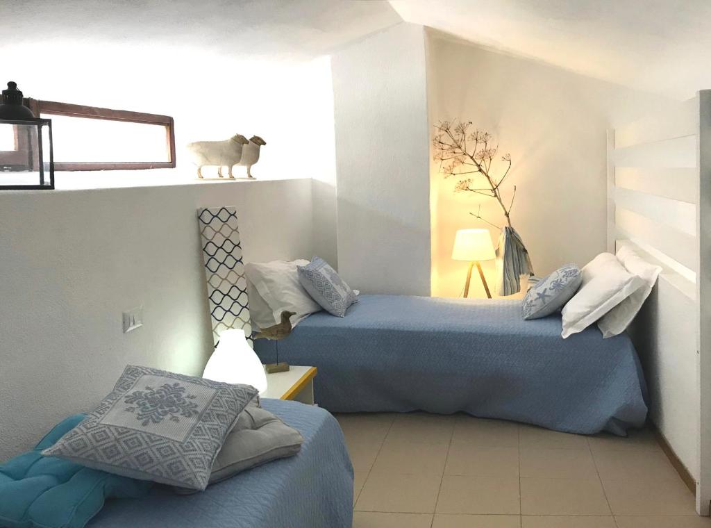 A bed or beds in a room at Terrazze di Chia