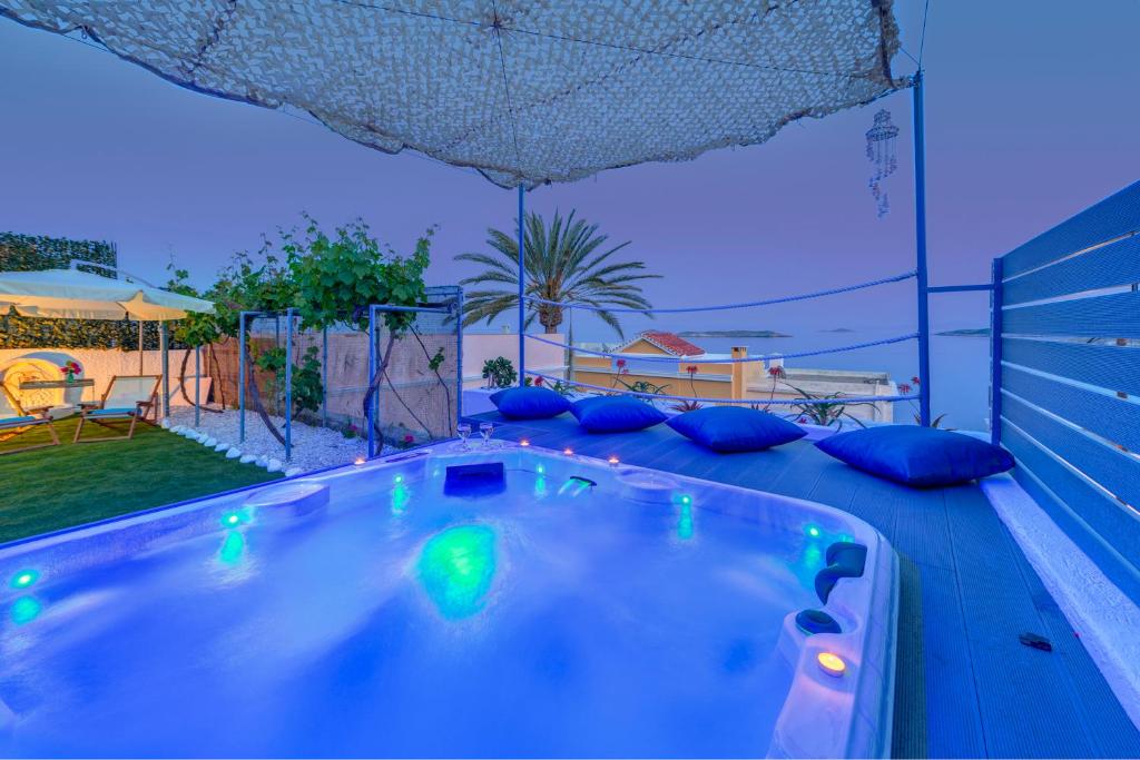 a jacuzzi tub with blue lights in a backyard at Veranda Syros House in Ermoupoli