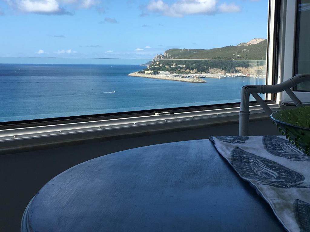 a room with a large window with a view of the ocean at Sun & Sea 512 in Sesimbra