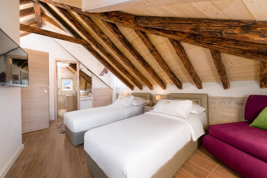 um quarto com 2 camas e um sofá em Agava Lux Rooms&Pool em Split