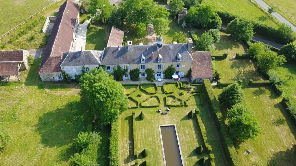 an aerial view of a large house with a yard at Le Domaine de Cordey in Boucé