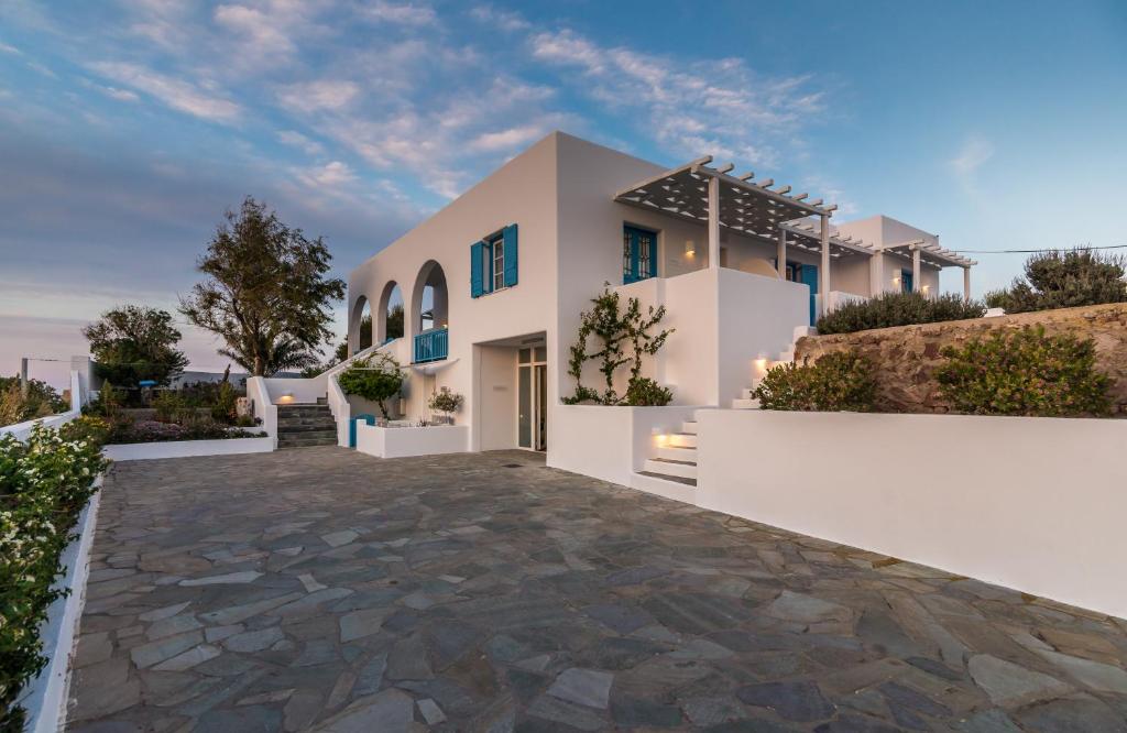 a villa with a driveway in front of a house at Eiriana Luxury Suites in Plaka Milou