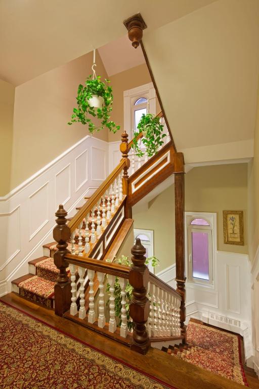 a home with a spiral staircase with a green wreath at Victoria's Mansion Guest House in Toronto
