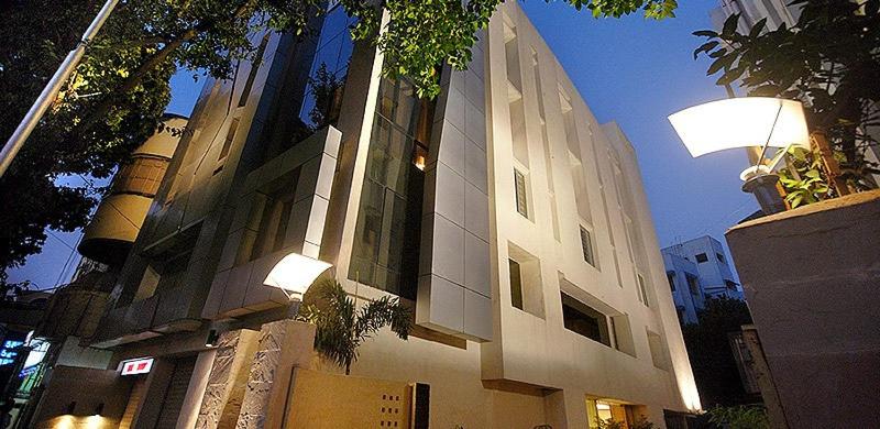 a building with a light on the side of it at Hotel Metropole in Kolkata