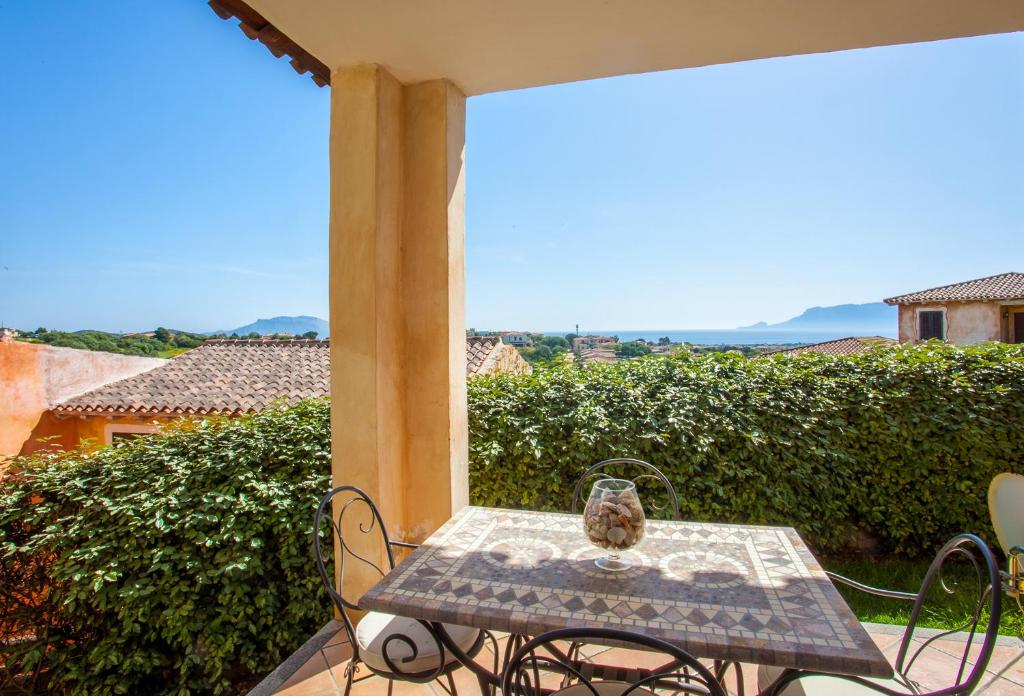 a table and chairs on a patio with a view at Belvedere Suites - Klodge in Olbia