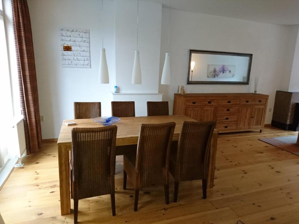 a dining room with a wooden table and chairs at Hiltje - Nice to stay in Dordrecht