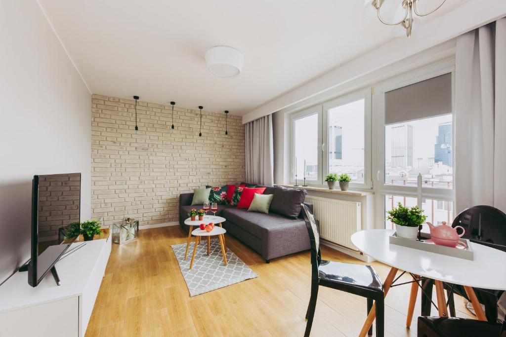 a living room with a couch and a table at oompH Warsaw Downtown Apartments in Warsaw