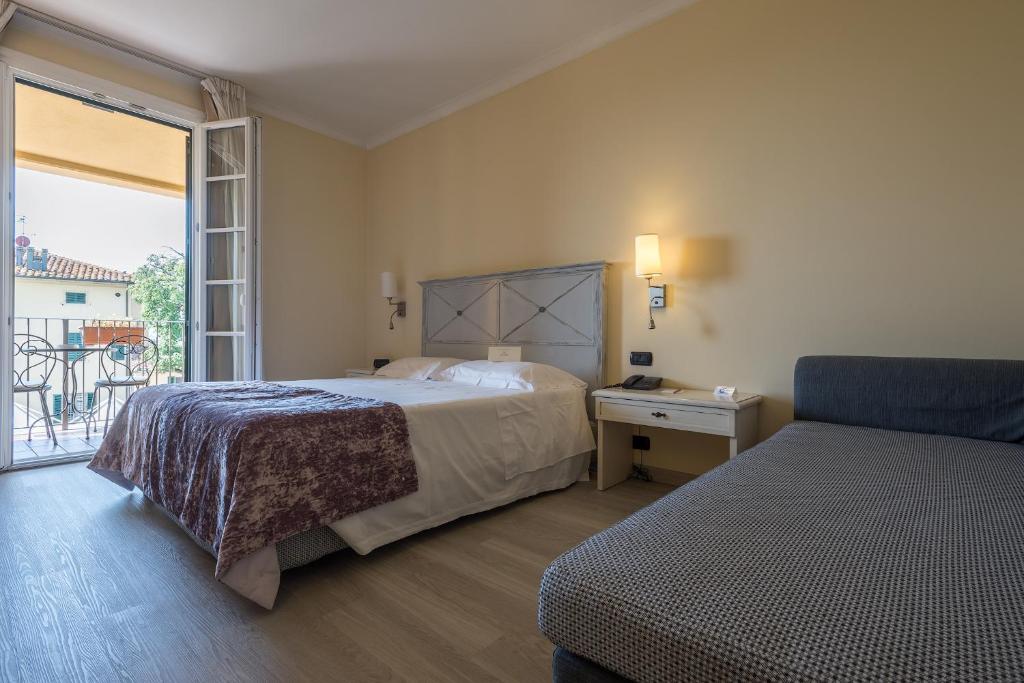 Postel nebo postele na pokoji v ubytování Hotel Villa Cappugi