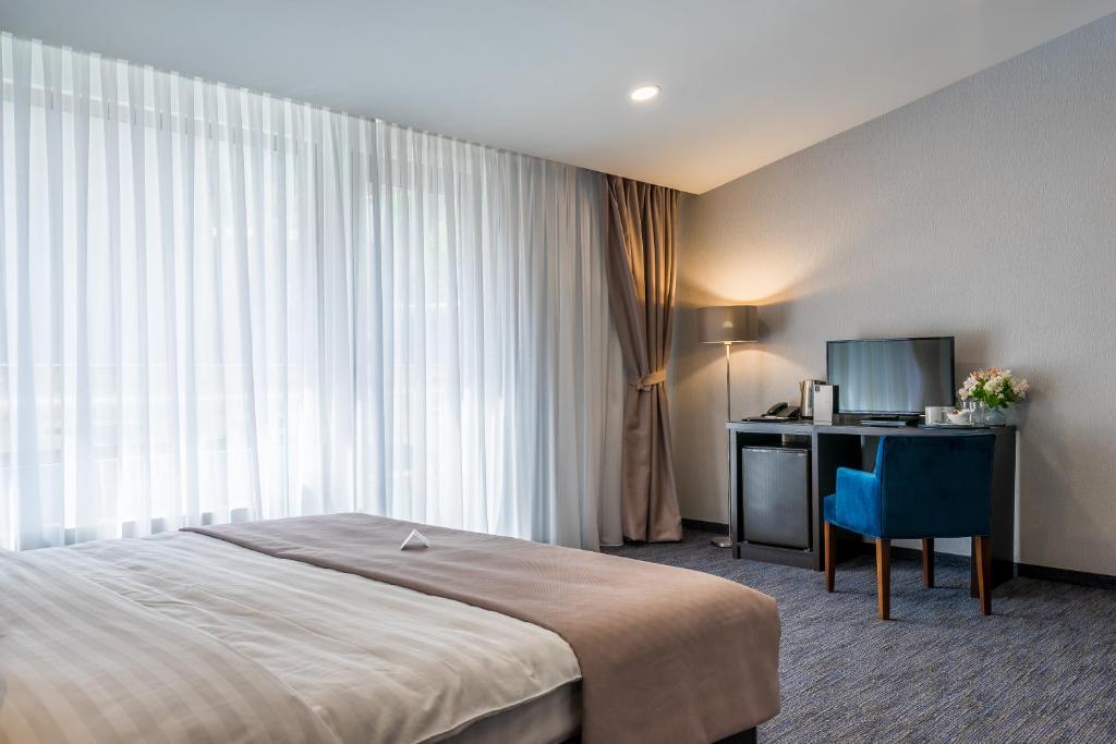 Postel nebo postele na pokoji v ubytování Hotel Bella Casa