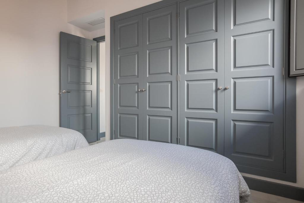 Postel nebo postele na pokoji v ubytování Casas de Sevilla - Apartamentos Tintes12