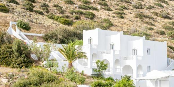 a white house in the middle of a hill at Nostos in Matala