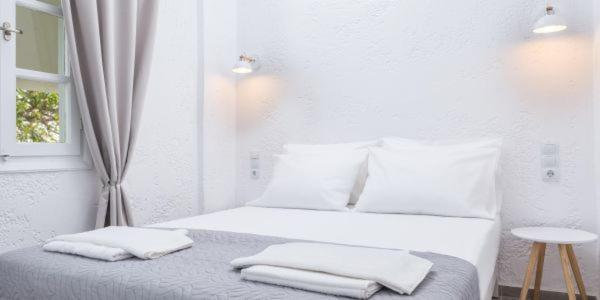 Postel nebo postele na pokoji v ubytování Nostos