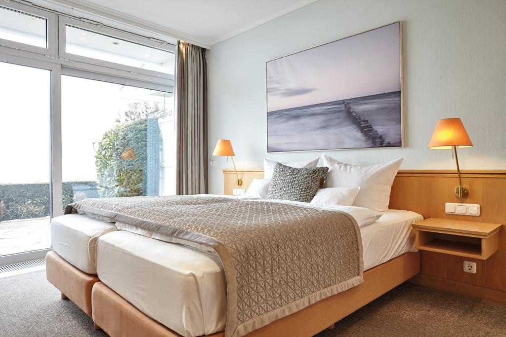 Postel nebo postele na pokoji v ubytování Hotel Strandidyll