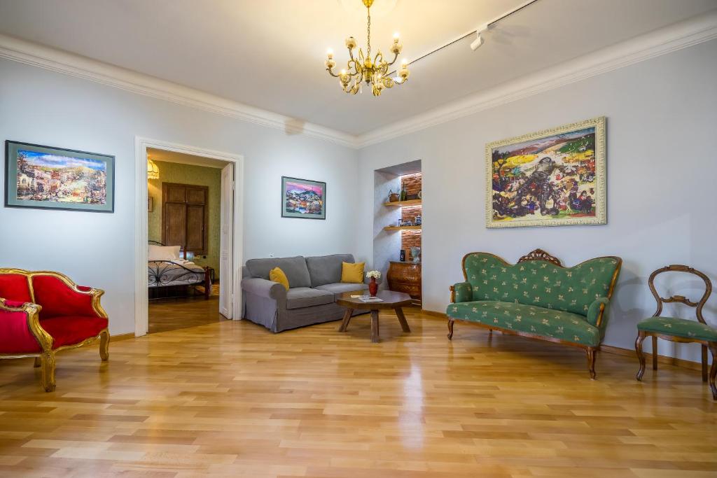 a living room with chairs and a couch at Gallery Apartment in Tbilisi City