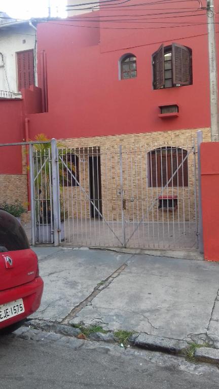 una cerca frente a una casa roja en Hotel Pousada Viana, en São Paulo
