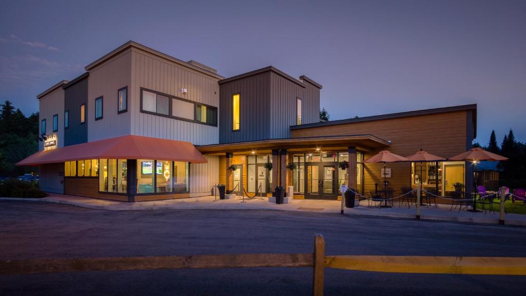 a building with a fence in front of it at Sun & Ski Inn and Suites in Stowe