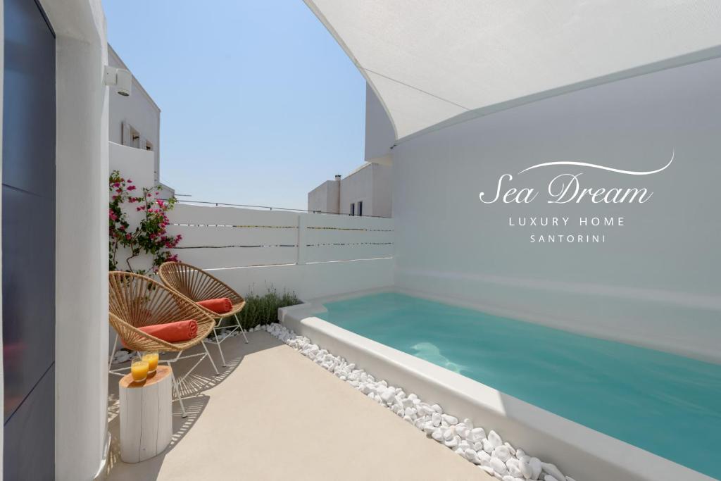 a swimming pool on the balcony of a house at Sea Dream Luxury Home in Fira