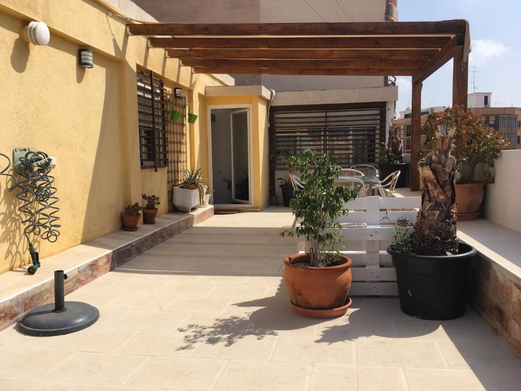 an outdoor patio with potted plants on a building at My Penthouse Valencia in Valencia