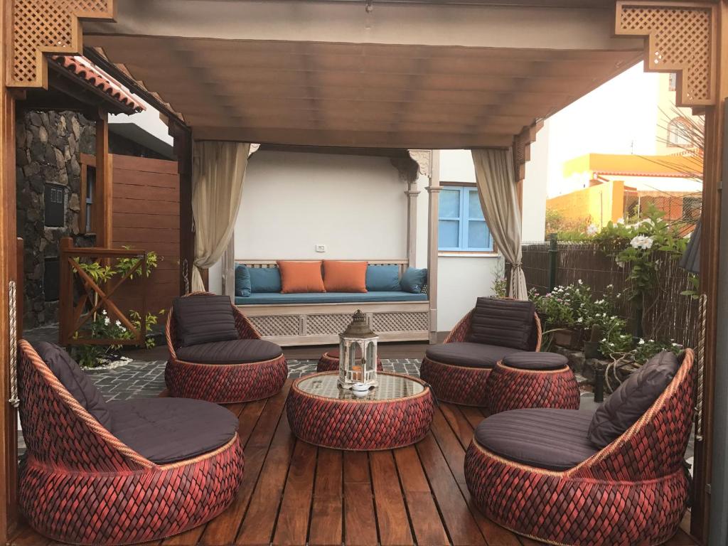 a patio with chairs and a table and a couch at Caserío de la Playa - Adults Only in Valle Gran Rey