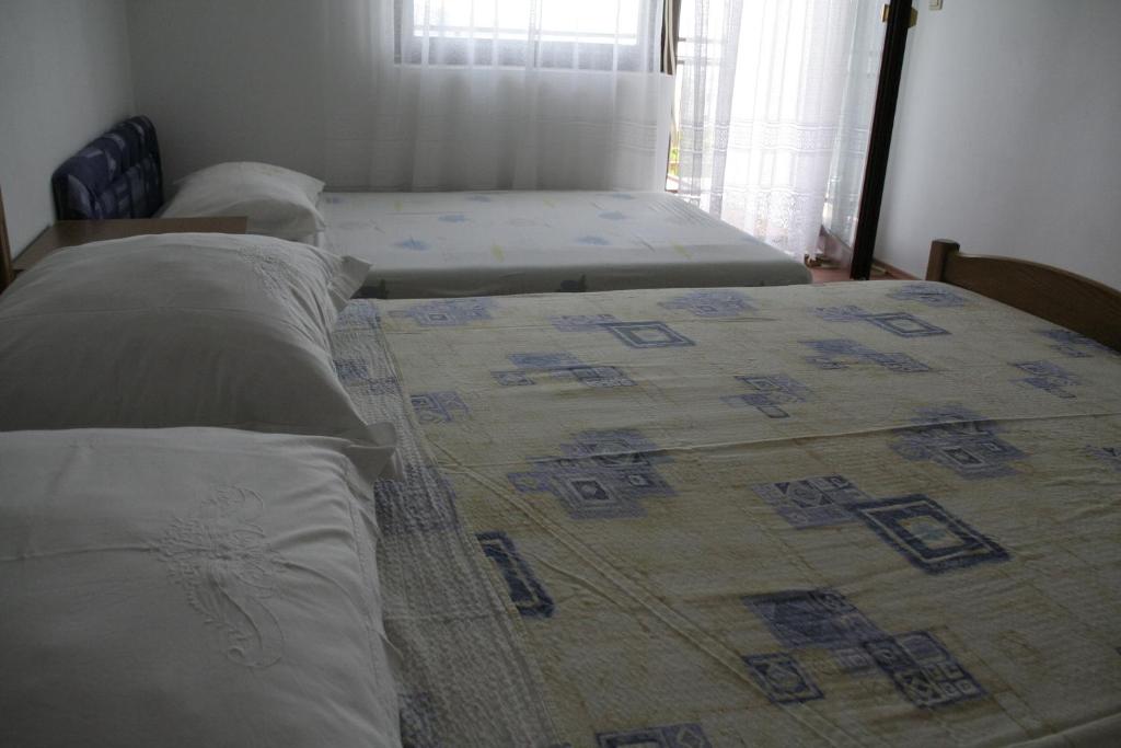 Postel nebo postele na pokoji v ubytování Apartmani Huljev