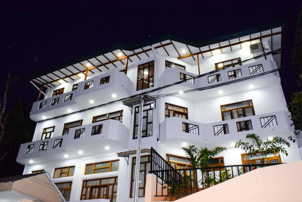 a white building with lights on it at night at SaRu Holiday Apartment - Up to 6 Guests in Kandy